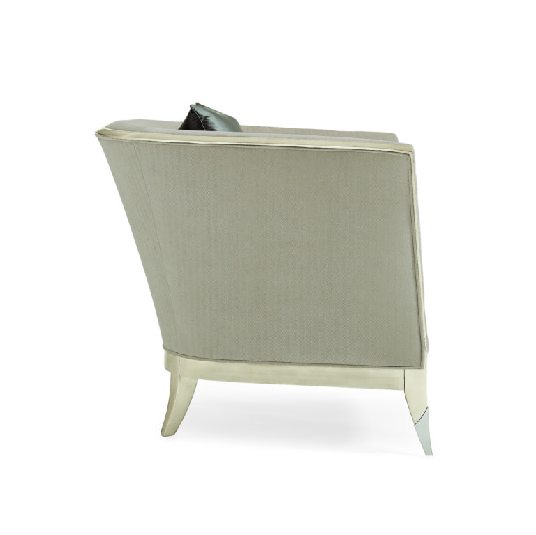 Unwind in a room that seamlessly blends contemporary styling and sumptuous comfort with this chic chair. Its sculptured silhouette features winged arms and is outlined in Soft Silver Leaf. Lightly Brushed Chrome ferrules add a glamorous touch.